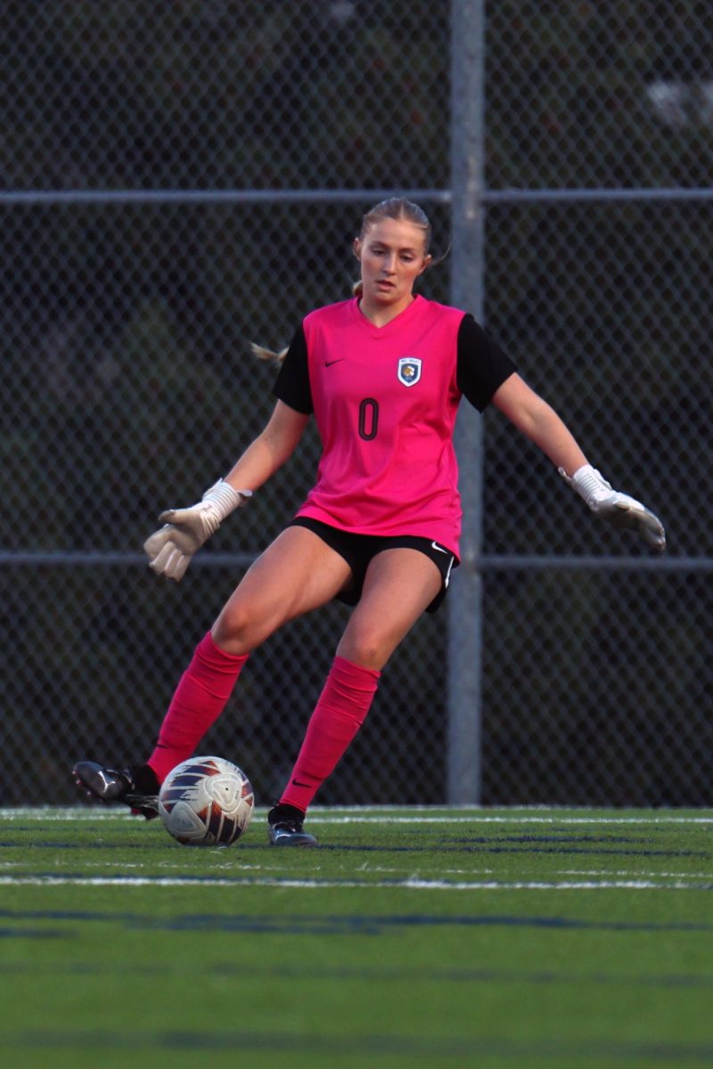 Eyes on the ball, sophomore Jamie Ricker passes the ball to a teammate.