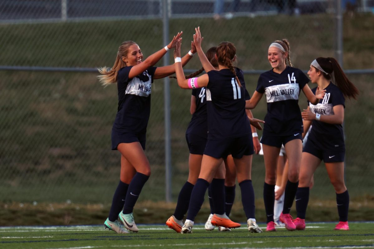 After scoring a goal, junior Calista Marx celebrates with her team.