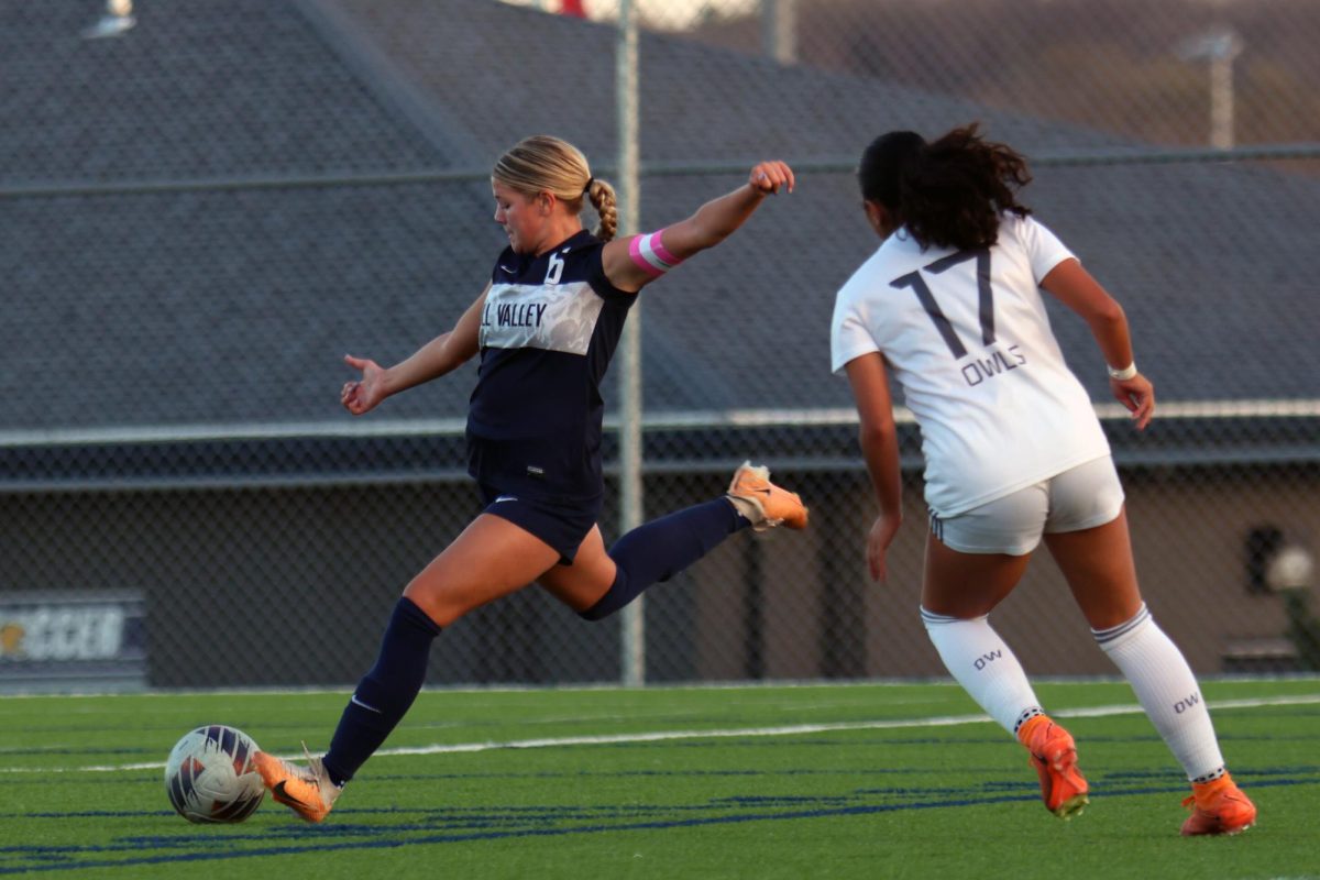 Arms out, senior Brooke Bellehumeur prepares to kick the ball.