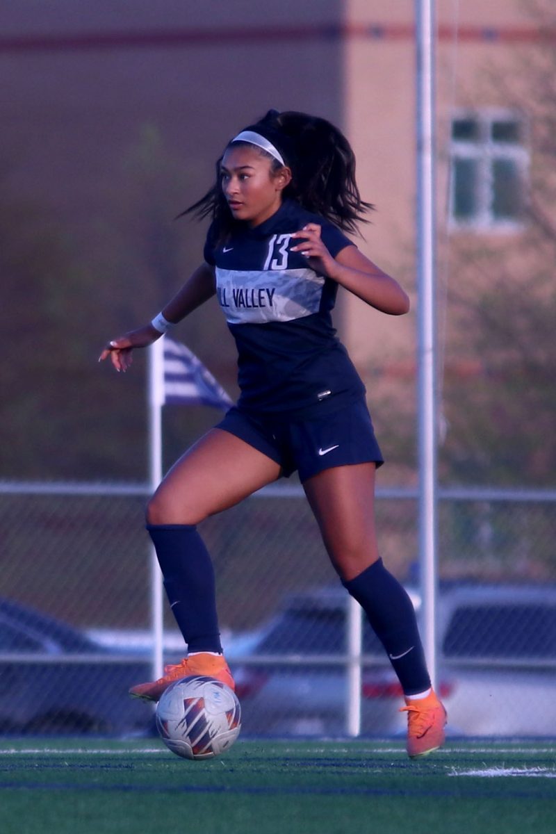 Eyes focused on the field, freshman Grace Garcia dribbles the ball.