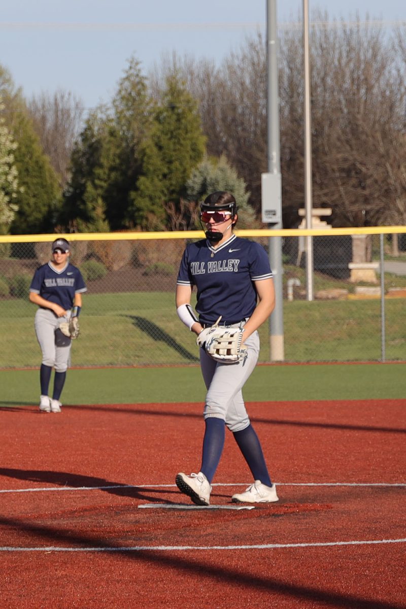 Stepping up, freshman Emma Hadley prepares for her next pitch.