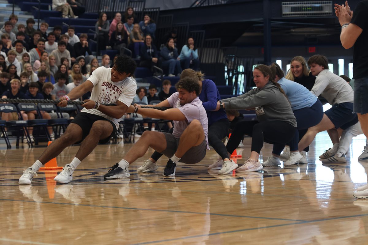 Laughing in the middle of tug of war, the juniors use the rest of their strength to attempt to win tug of war against the seniors.