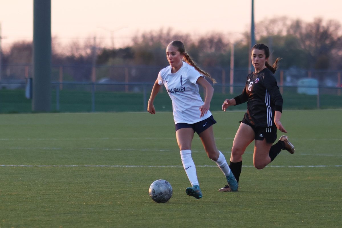 With an opponent on her tail, a player flys down the field looking to score a goal.
