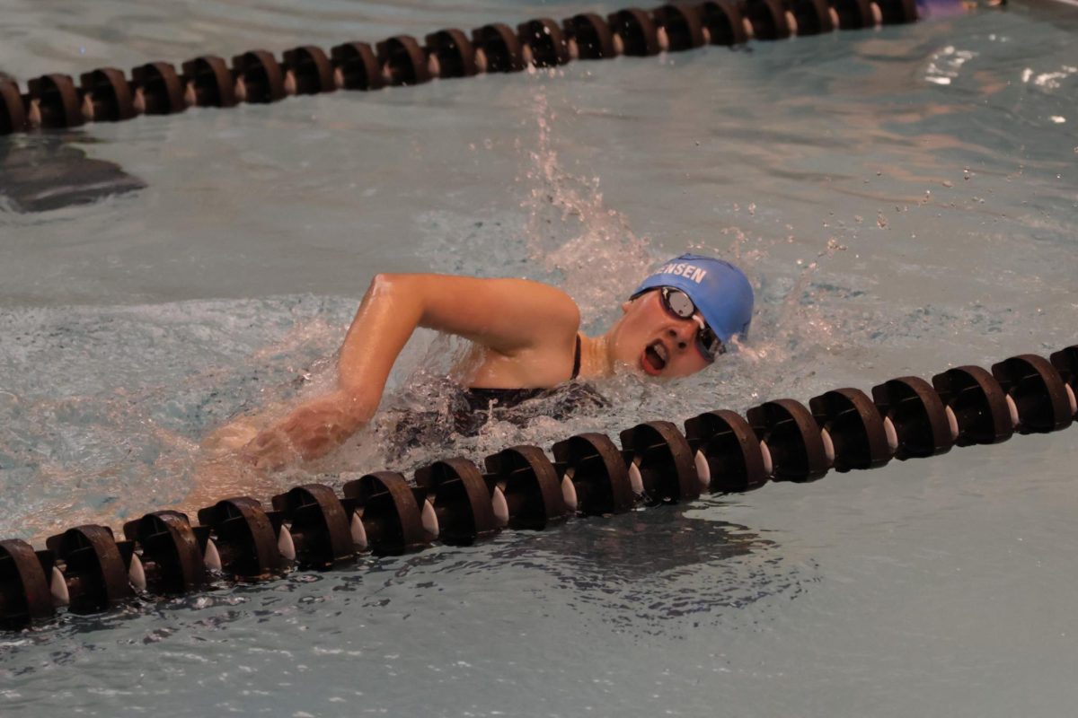 Feeling tired, sophomore Hannah Stephensen takes a big breath while swimming the 500 yard freestyle.