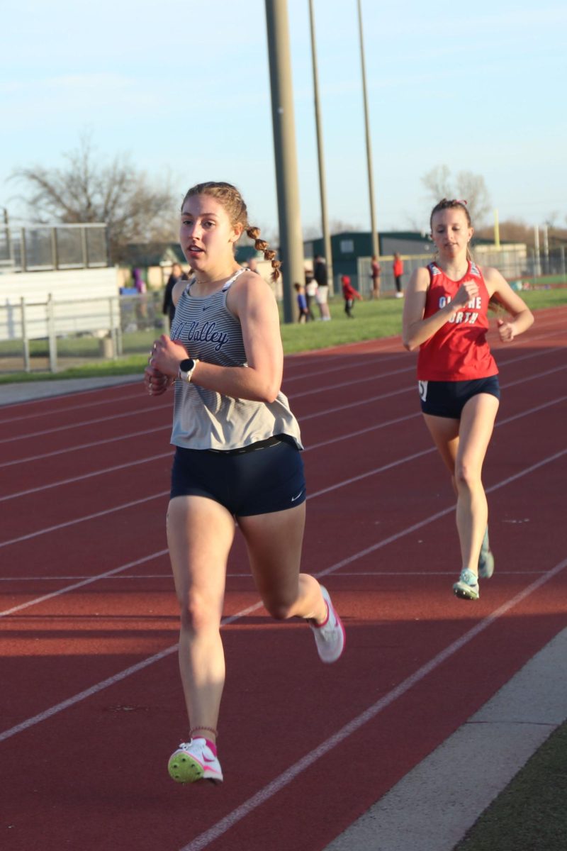 Opening her stride, senior Sarah Anderson secures her place in the 1600 meter race.