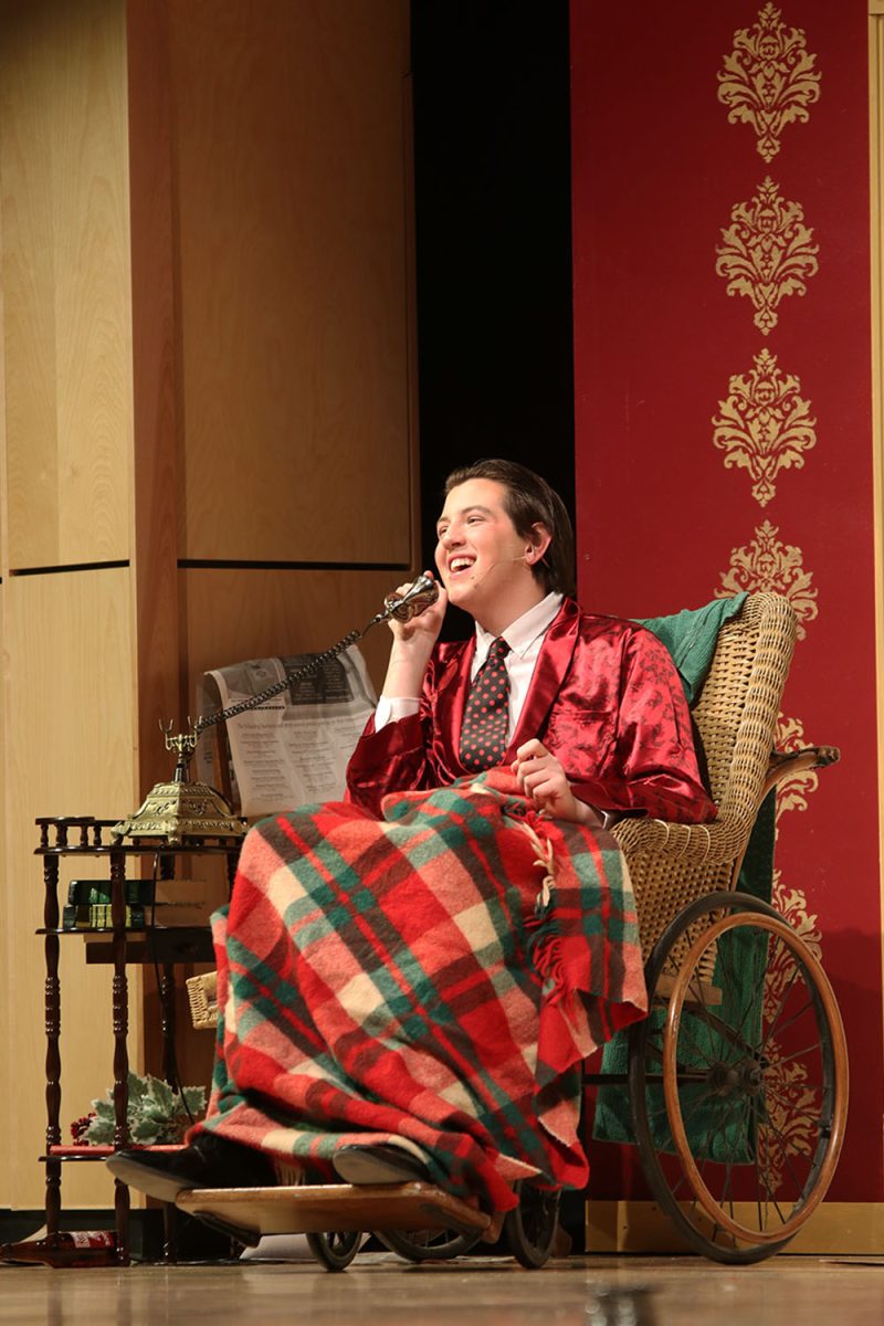Laughing, Mr. Whiteside, played by sophomore Barron Fox, talks on the phone to an old friend.