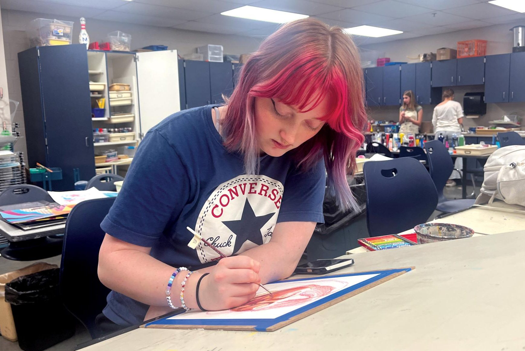 Senior Emma Clement works on perfecting her color in a self portrait Monday, April 8. Clement submitted a portfolio with eight art pieces to the Shooting Stars contest that she worked on in her Advanced Painting and AP Art classes.
