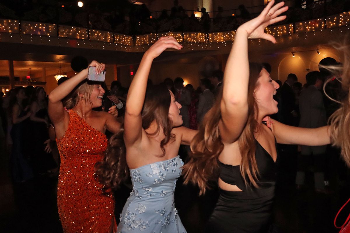 Seniors Jaiden Fisher, Ellie Walker and Lucy Roy dance in a conga line circle.