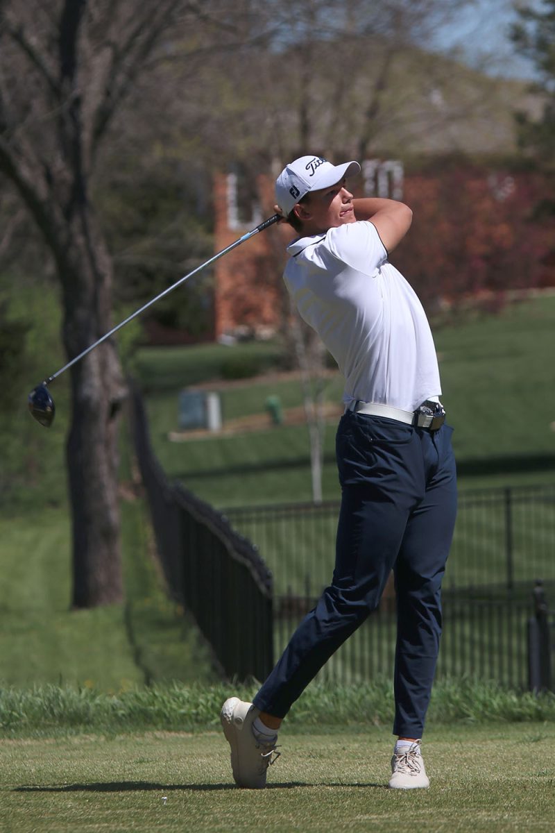 Finishing his swing, senior Broden Resch stands in the tee box. 
