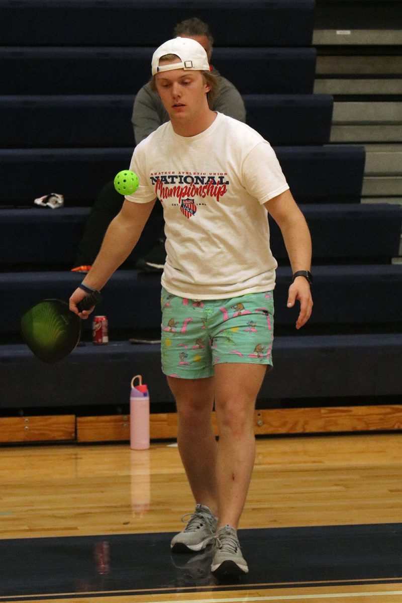 Watching carefully, junior Clayton Sondgeroth hits the ball. 
