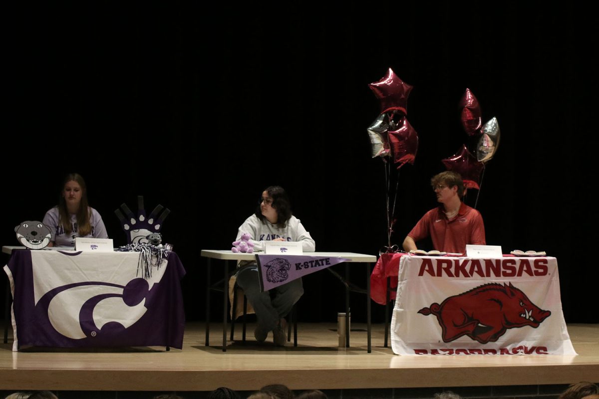 Listening to choir teacher Jessie Reimer, seniors Kate Marten, Augusta Miller and Blake Powers all watch their teacher. 
