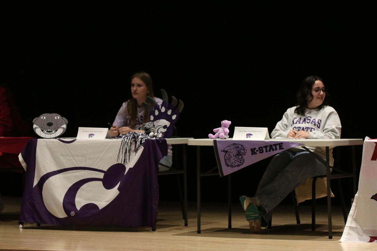 As both seniors Kate Marten and Augusta Miller prepare to sign for Kansas State University, they share a moment with their peers. 