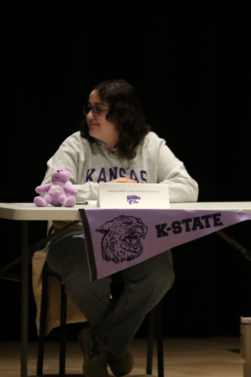 Senior Augusta Miller, signing for Kansas State University, looks at her friends that are also signing. 
