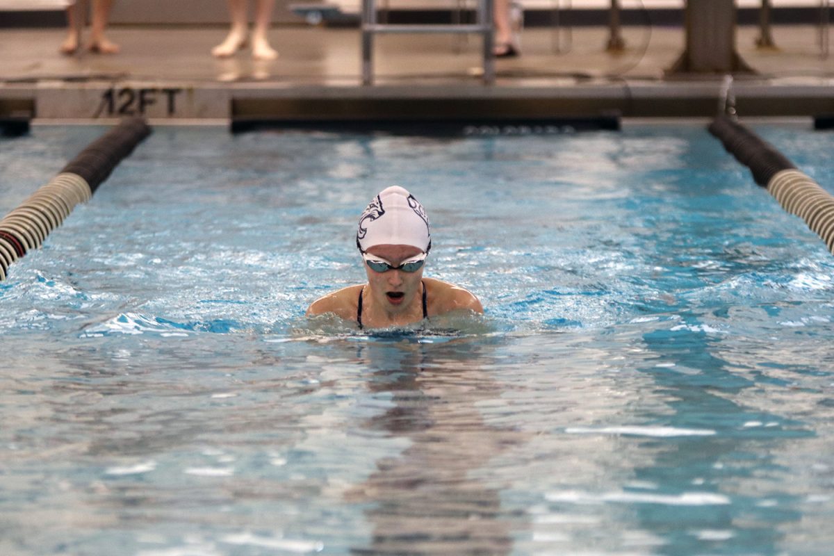 Mid race, junior Kennedy Goertz comes up for air during her 100 year breaststroke.