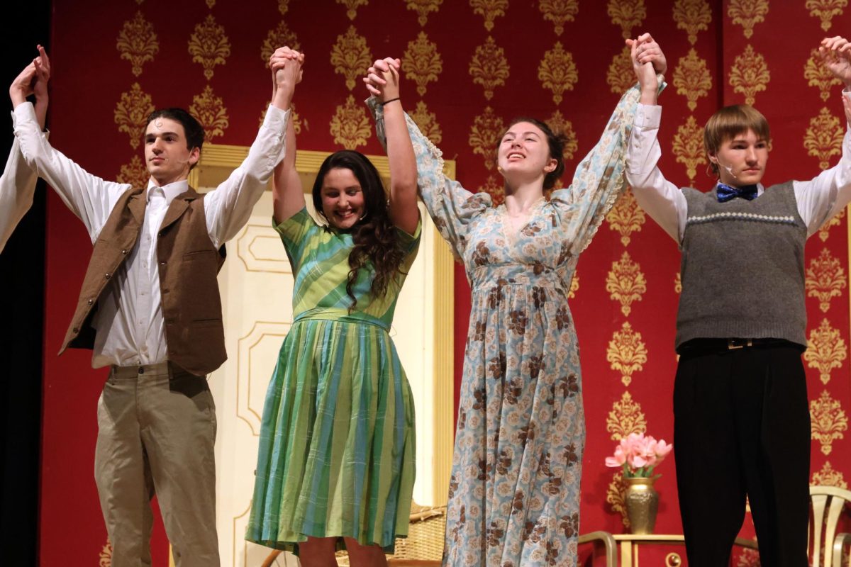 Raising their hands in the air, junior Zach Casper and freshmen Lacey Jennings, Natalie Long and Zane Hodson prepare to bow during curtain call.