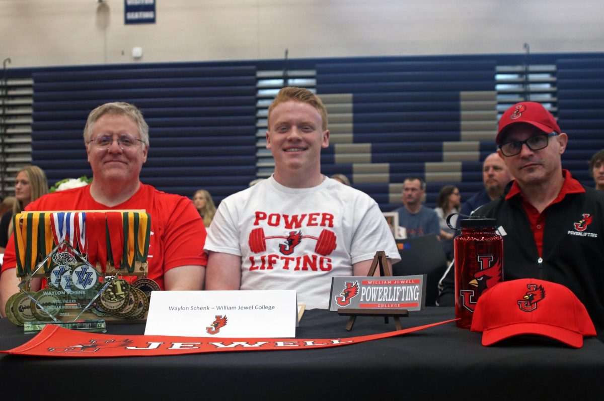 Signing at William Jewel College, senior Waylon Schenk prepares to continue his powerlifting career. 