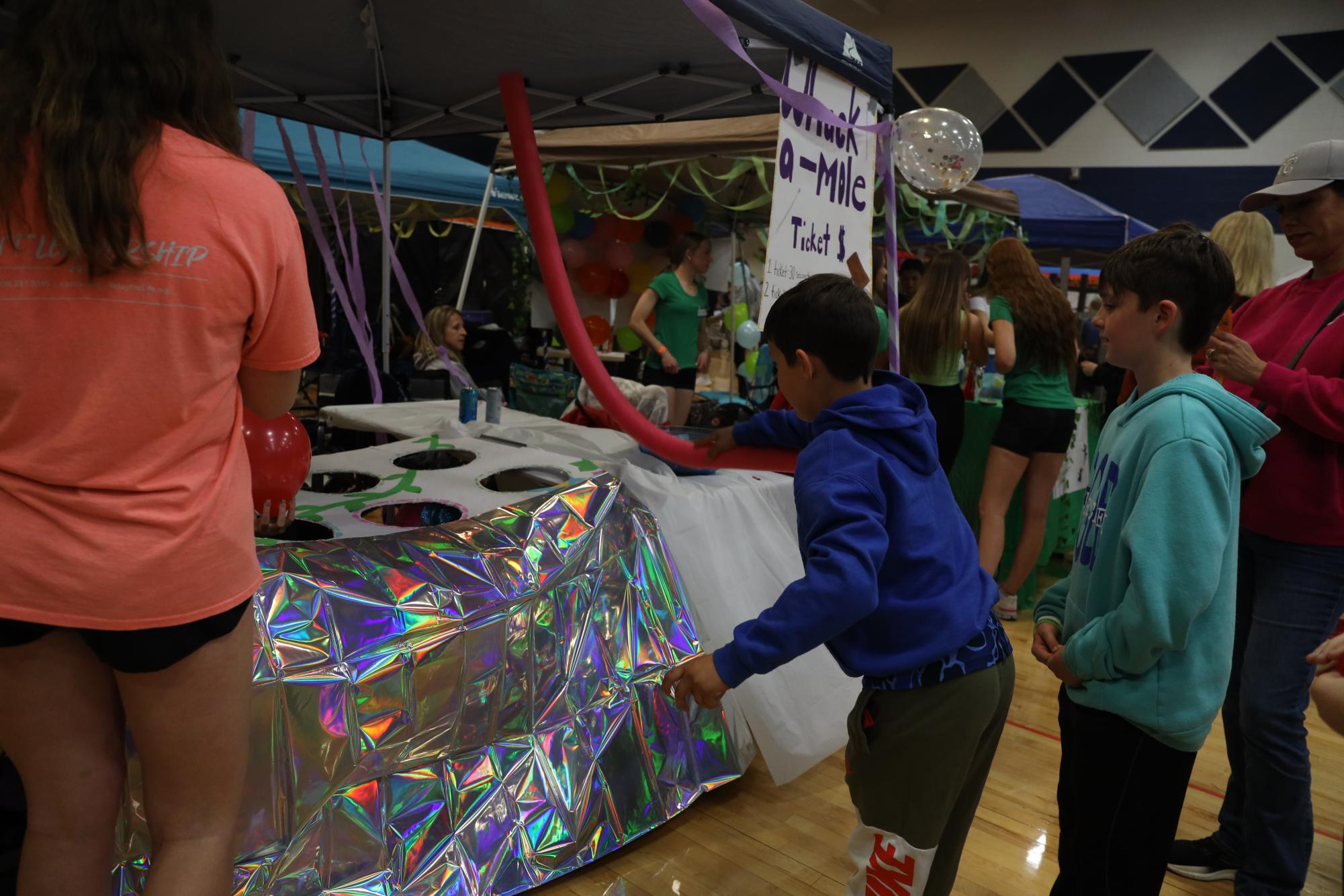 Pool noodle in hand, one of the Relay for Life guests plays student-made “Whack a Mole.”