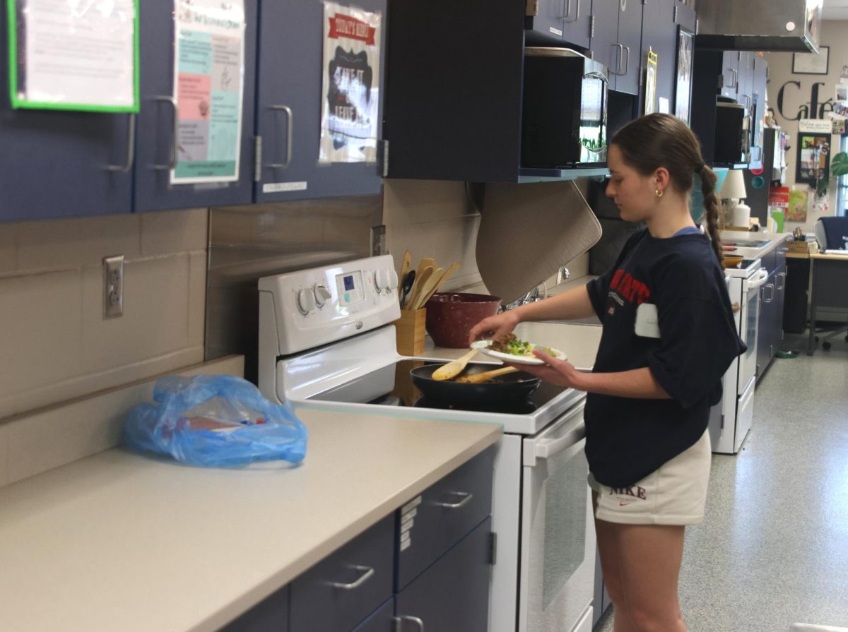 Junior Ellie Walker assembles her taco she prepared with her SNHS members.