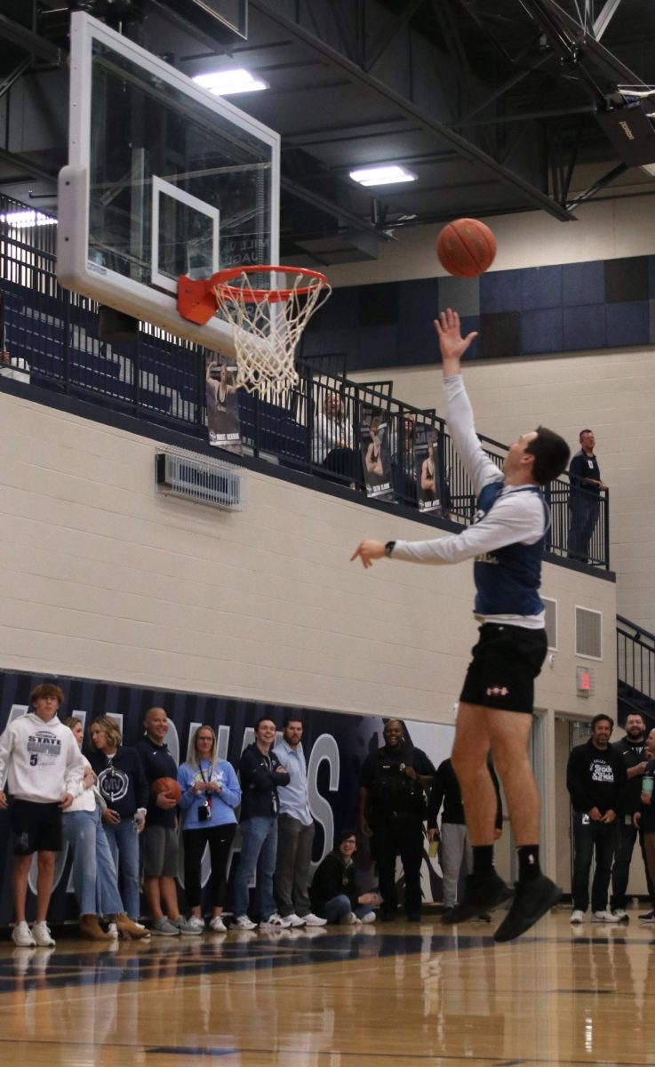 Making the shot, paraprofessional Curt Golubski, scores a point for the teachers team.