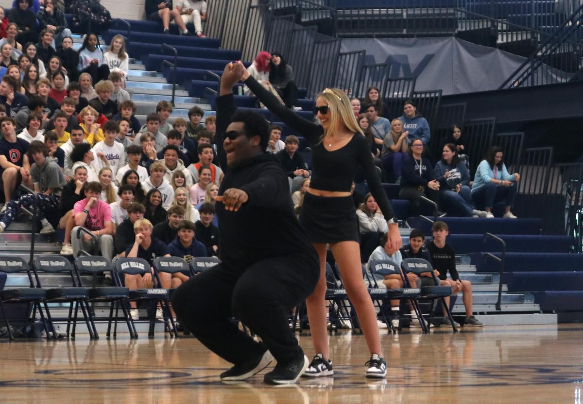 Partnered up, seniors Reagan Roberts and Adam McClendon perform the dance they made for the assembly.