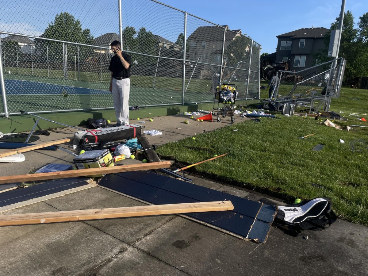 Faculty members begin the process of cleaning the damage from the storm Sunday May 19th.
