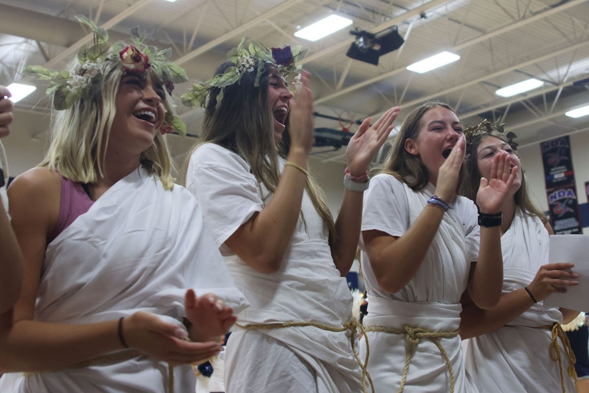 Wearing their togas, seniors Logan Miller, Ashlyn Blazer, Arye Meyer and Gracie Kurzejeski cheer for the freshmen.