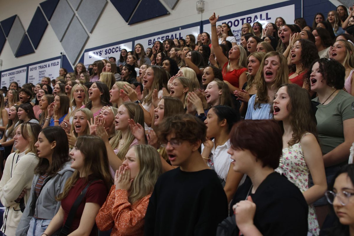 Showing their school spirit, the freshmen practice their chants.