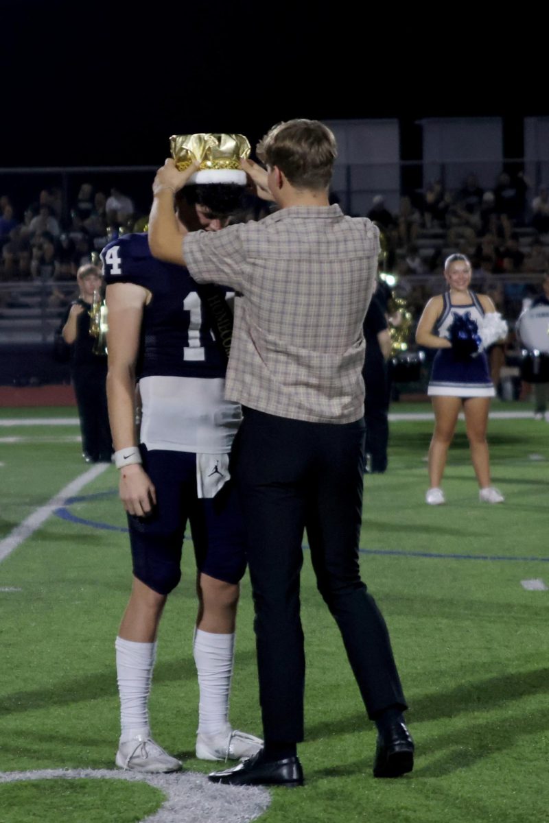 Homecoming King Connor Bohon gets crowned by 2023 Homecoming King Blake Powers.