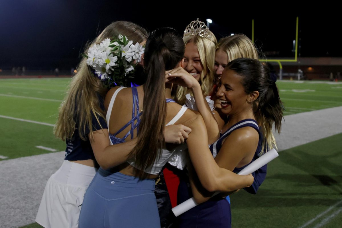 After the coronation, Homecoming Queen Maggie Wieland hugs seniors Jada Winfrey, Calista Marx and Isabel Cherrito.