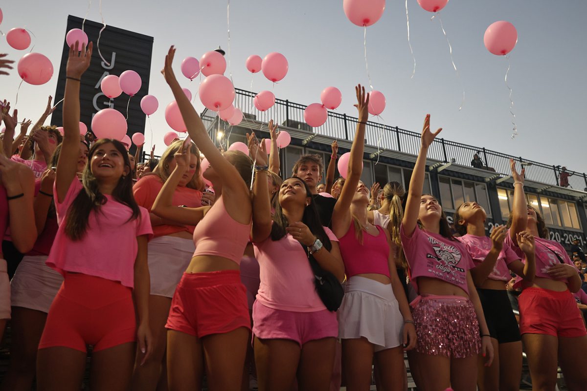 Looking up, students release balloons into the air in honor of cancer patients and survivors. 
