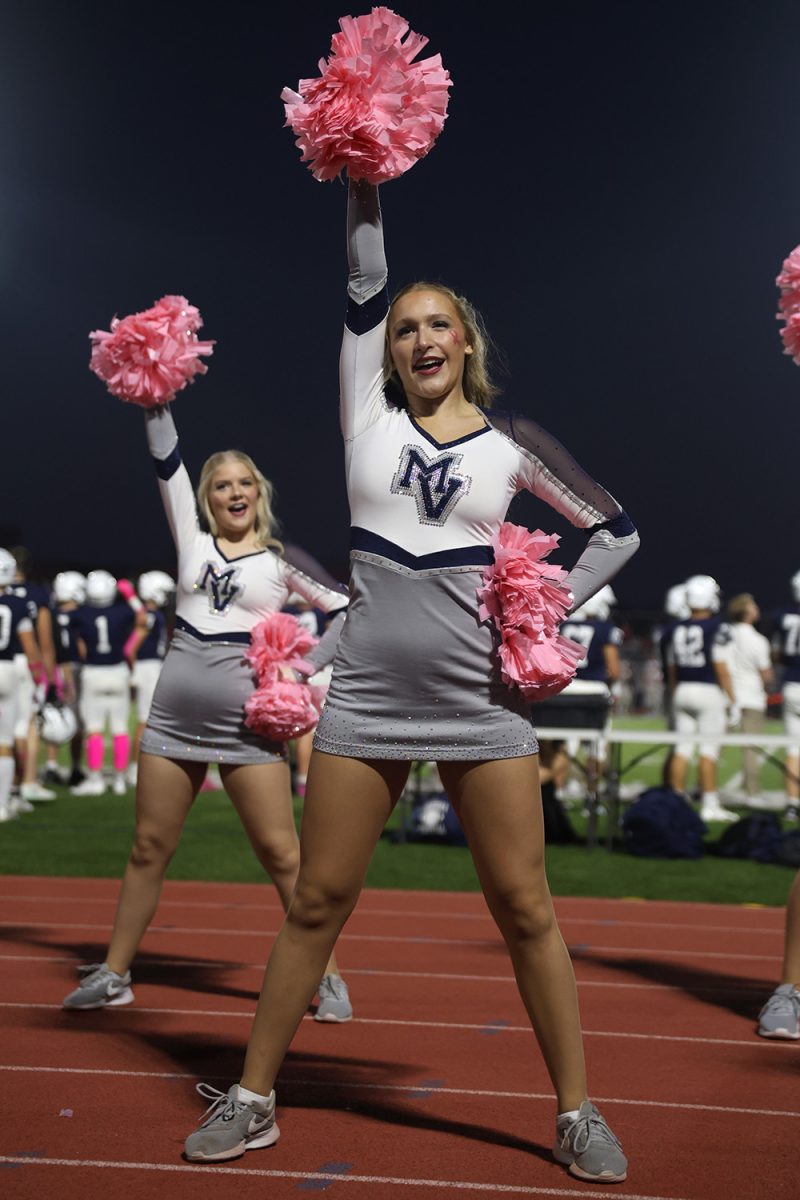 Arm up, senior Ashley Ayers dances with her teammates.