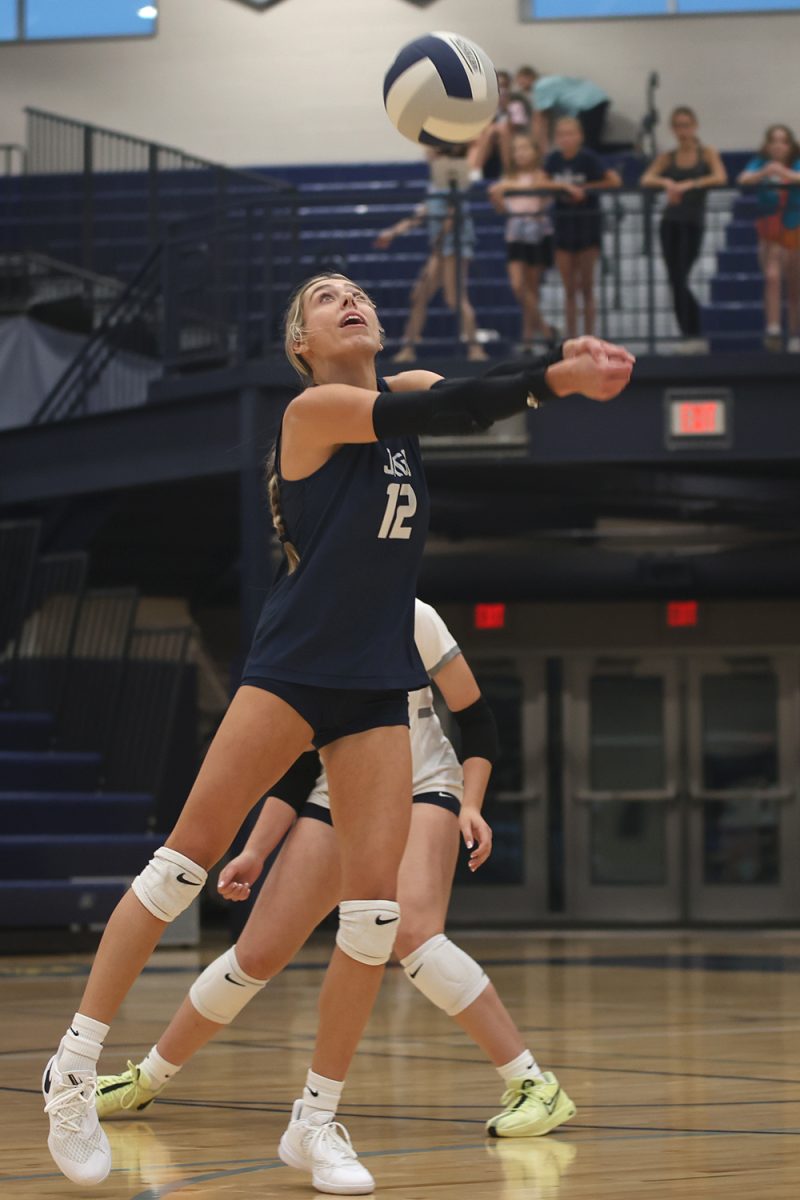 With a step, junior Corinne Schwindt reaches out to pass the ball Tuesday, Oct 1. 