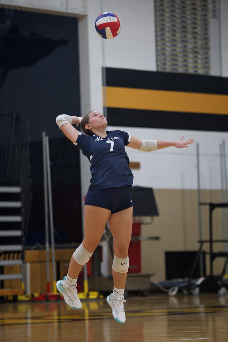 Eyes on the ball, senior Brynn McGillicuddy prepares to serve it over the net Thursday, Oct 3.