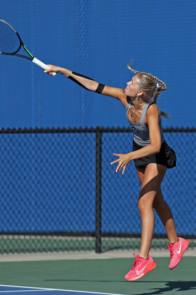 Junior Bryn Foltz serves the ball during a doubles match with partner senior Marissa Hoelting.