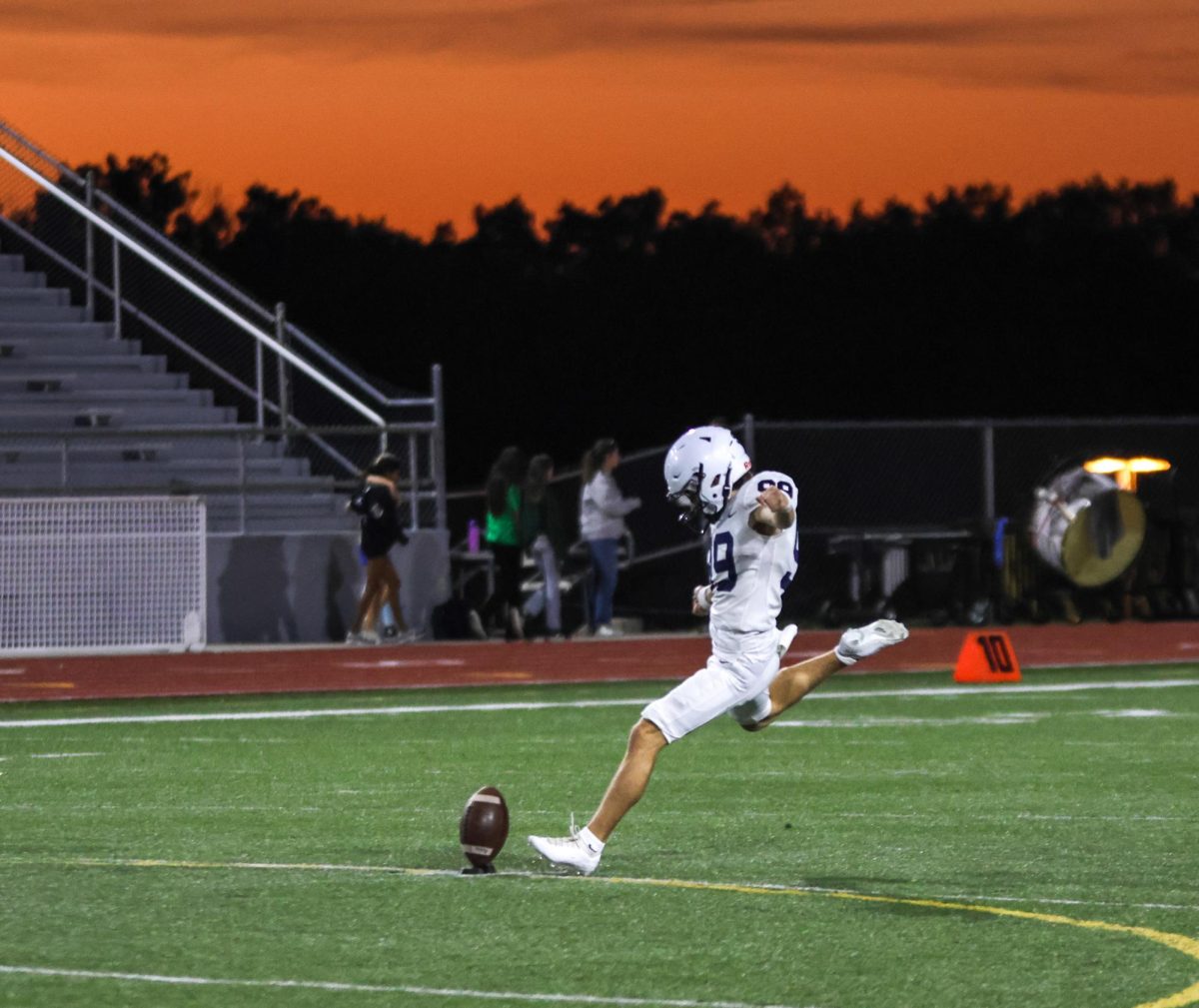 Senior Aidan Stanley kicks off under the sunset