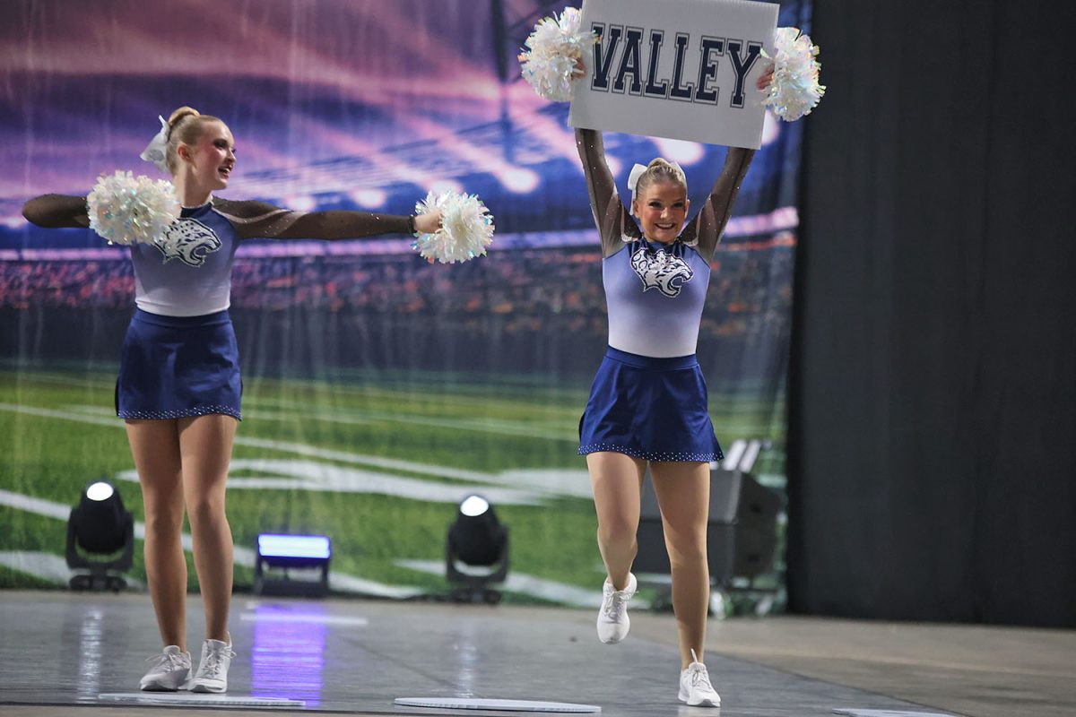 Smiling out to the crowd, junior Sydney Lenon holds up a ‘Valley’ sign.