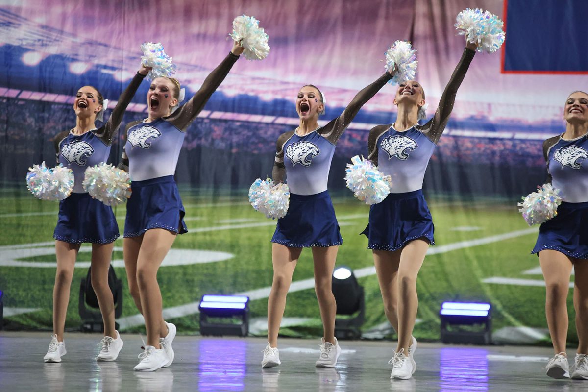 One pom in the air, the team dances and shouts chants along with the crowd.