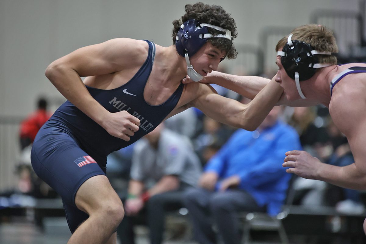 Arm up, sophomore Luke Whisler fights to bring his opponent down.