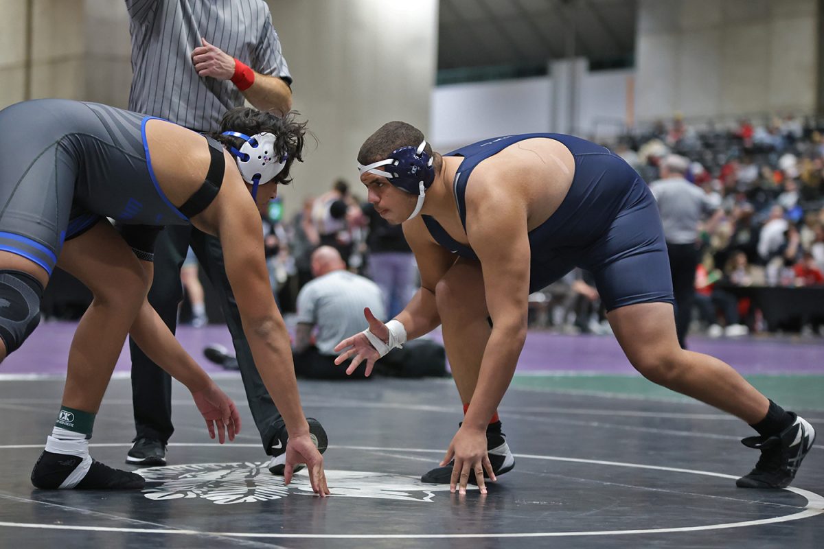 Crouched down, junior Lamarcus Barber gets ready to start his match.