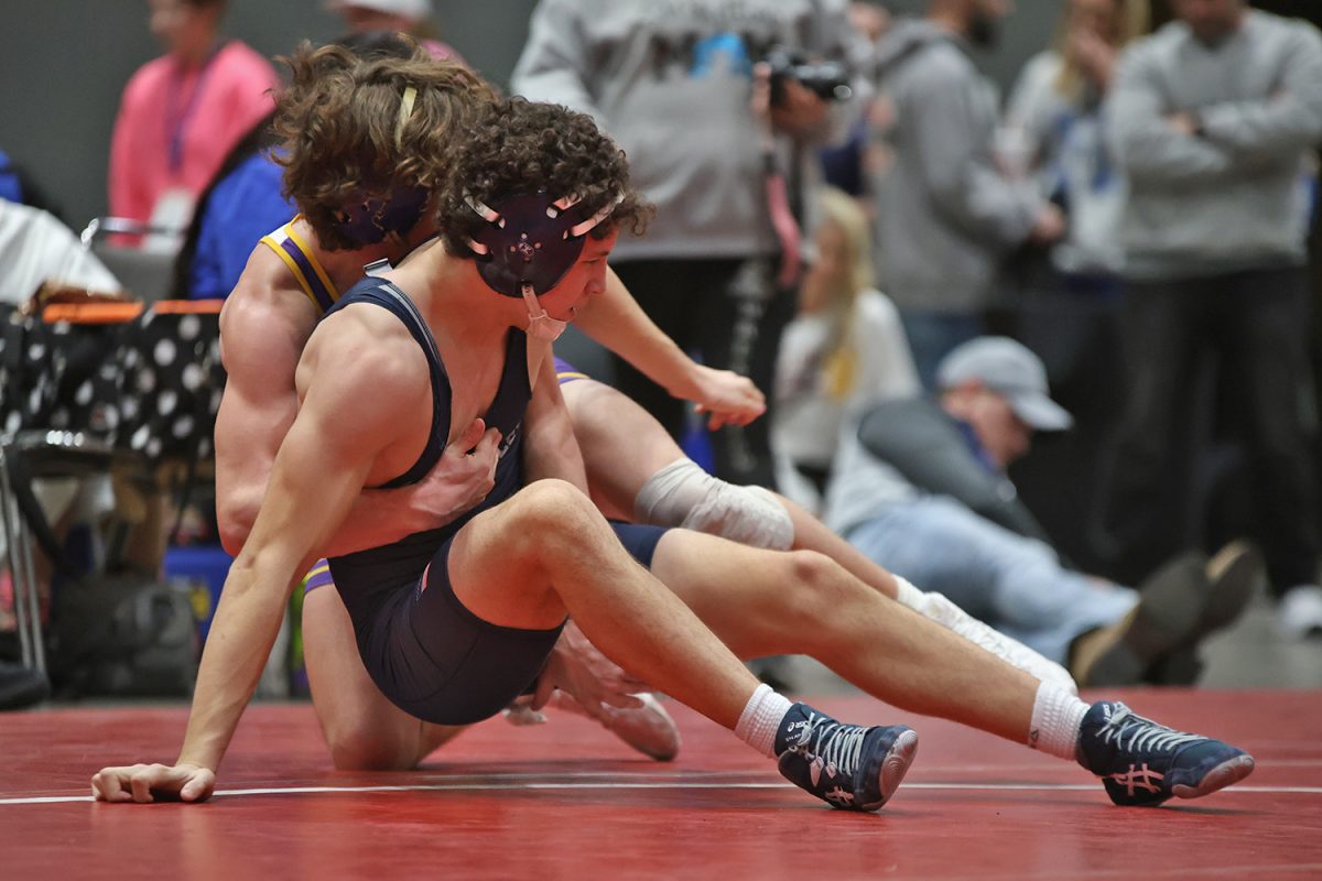 Trapped by his opponent, sophomore Luke Whisler works to get free from his grasp.