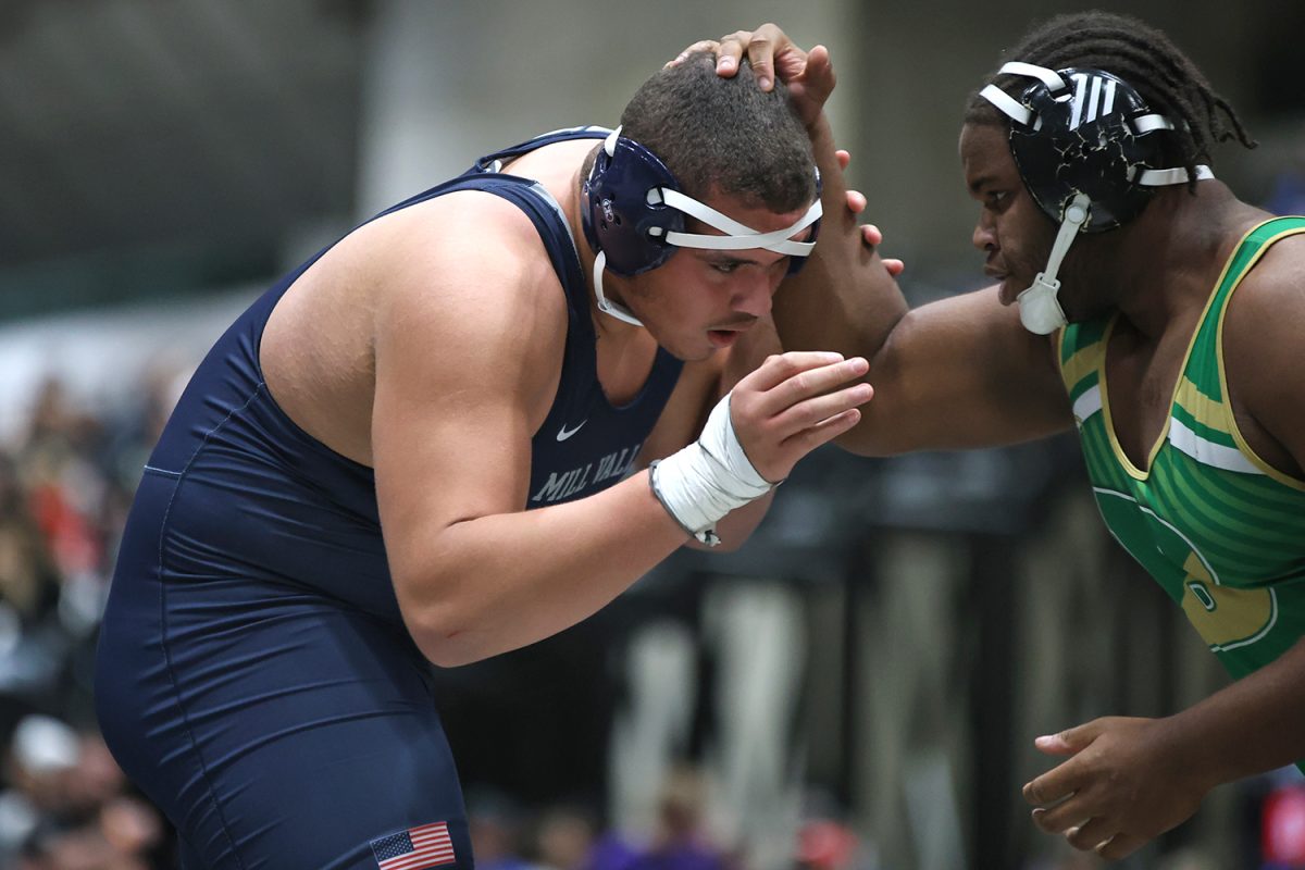 Junior Lamarcus Barber engages in hand fighting against his opponent.