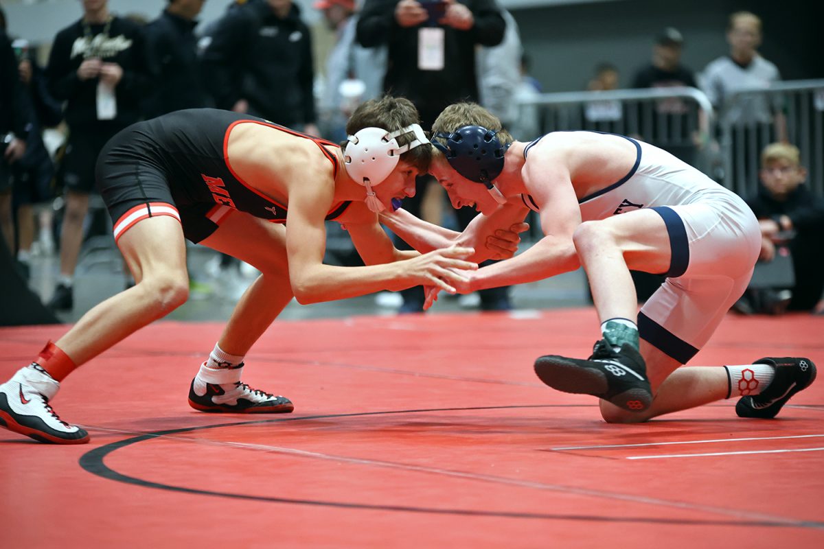 Low to the ground, junior Jeredy Nilges shoots to take his opponent down. 