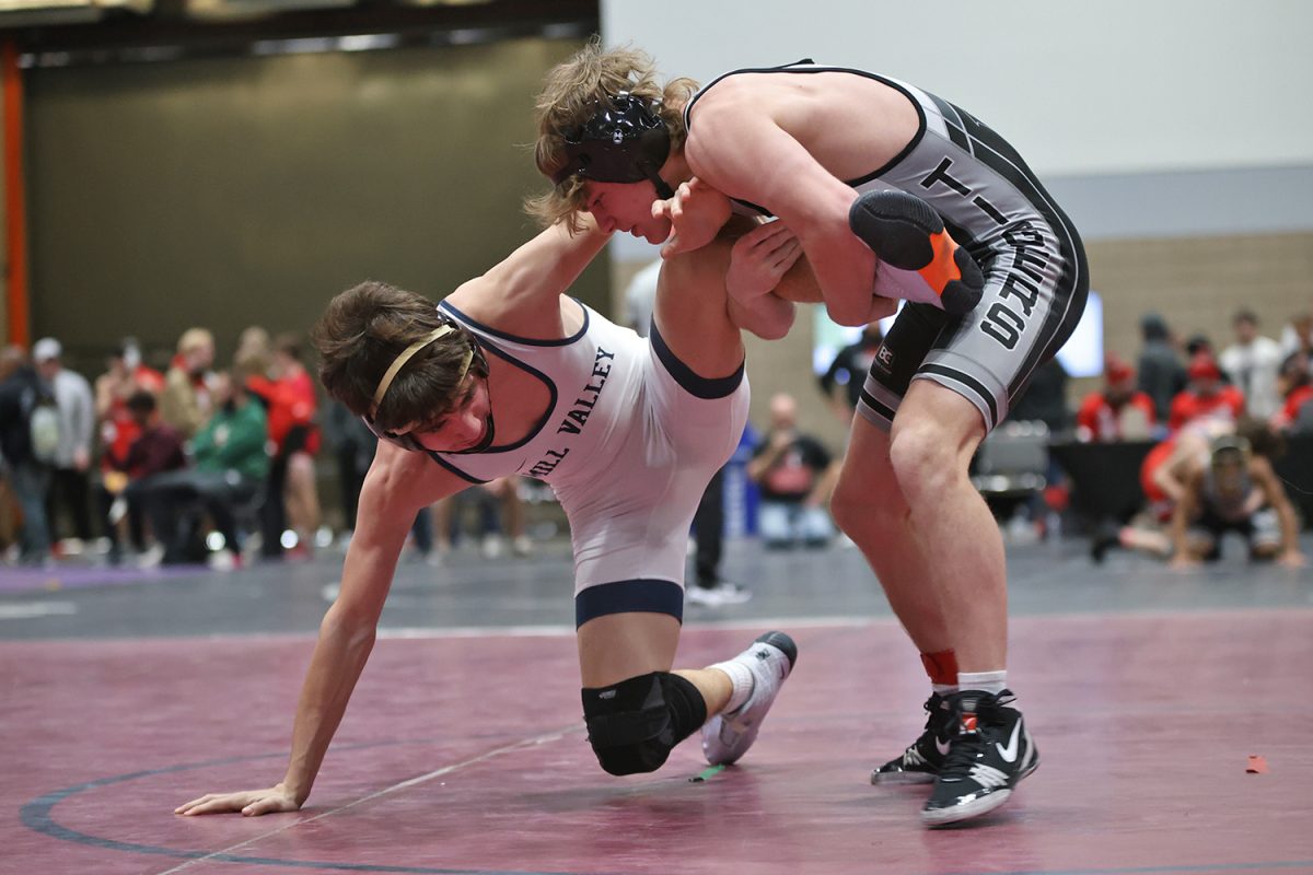 Balancing himself, sophomore Ethan Leon tries to get his leg free from his opponent.