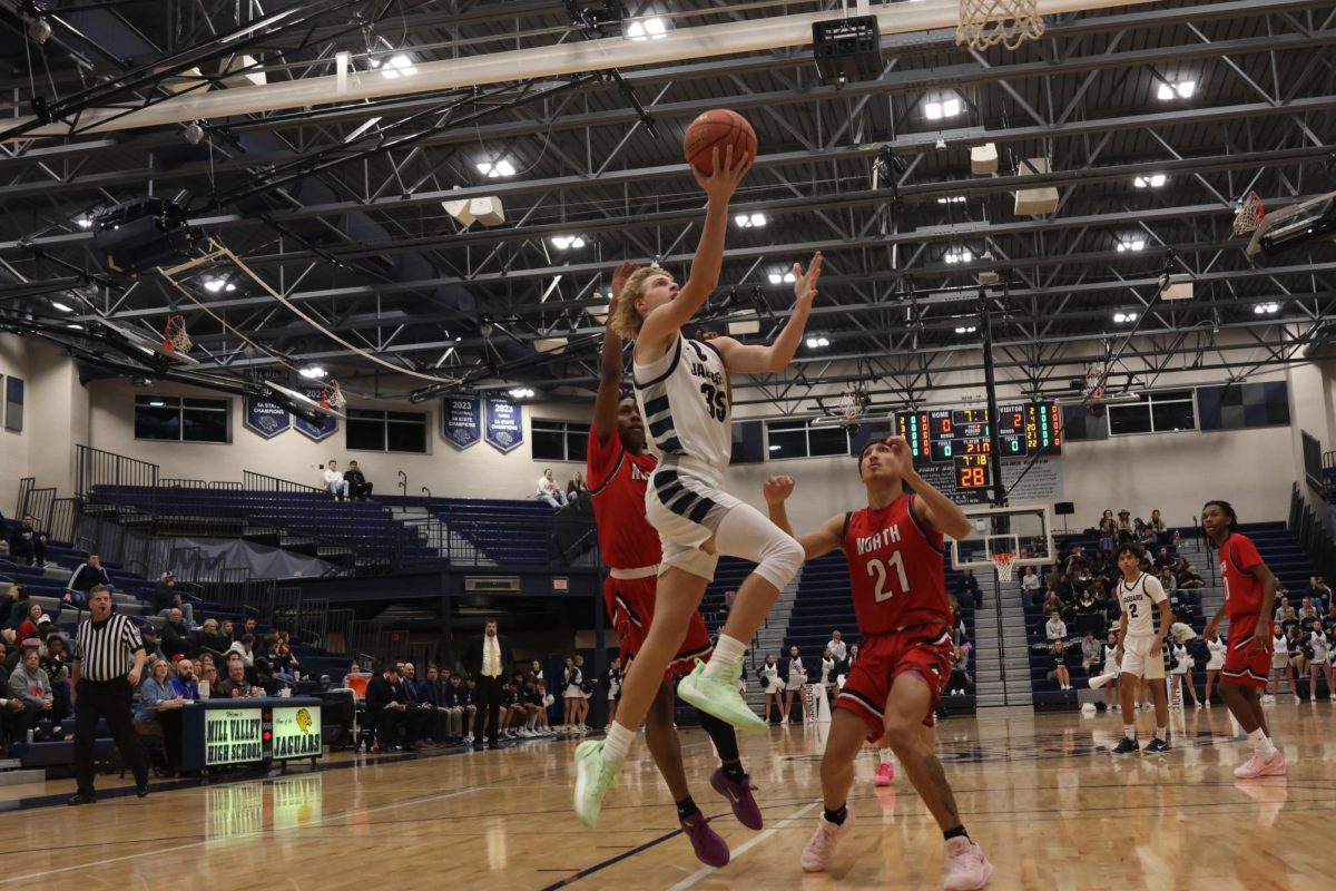 After beating the defense, junior Dylan Everhart goes up for a layup.
