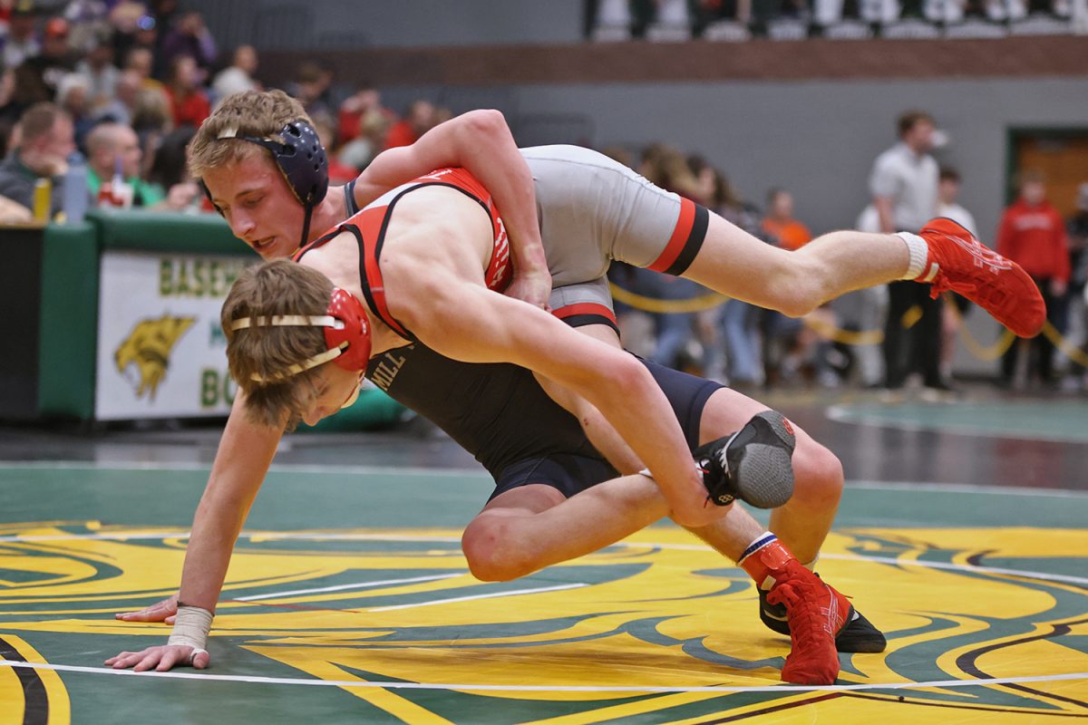 Focused, junior Jeredy Nilges brings his opponent down to the mat. 