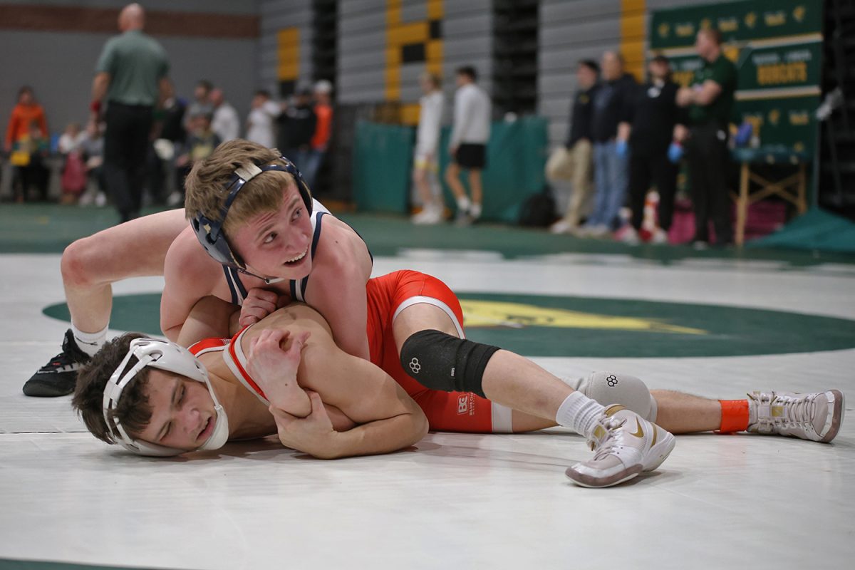 With a glance at the clock, junior Jeredy Nilges works to flip his opponent. 