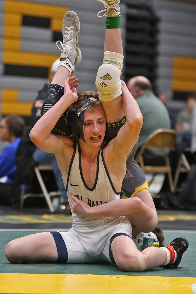 Holding his opponents legs, junior Jeredy Nilges pauses to figure out his next move.