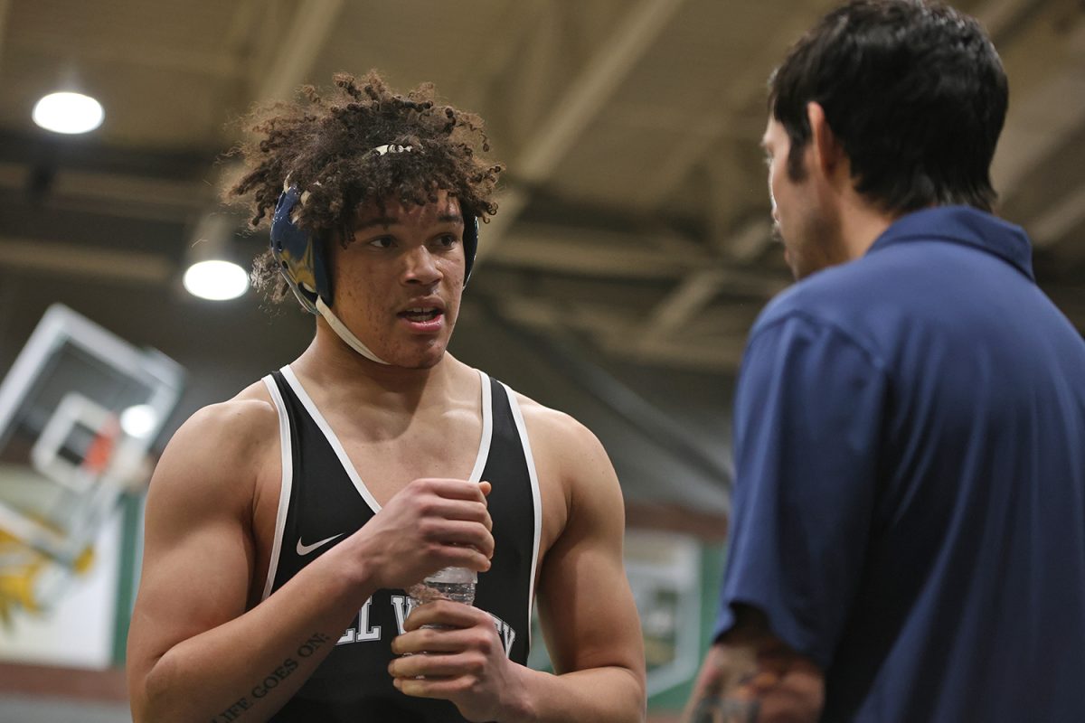 Grabbing some water, Junior MJ Wash talks to his coach during injury time. 