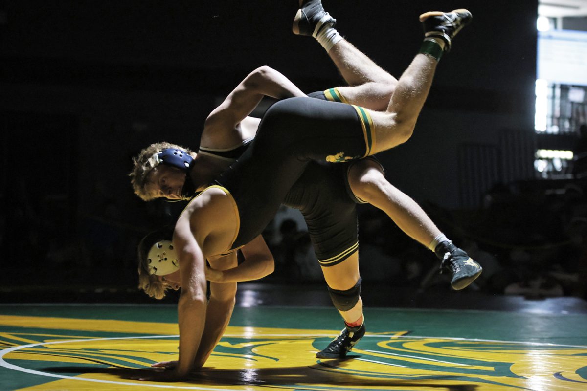 During the finals match, senior Colton Bendure drops his opponent to the mat. 