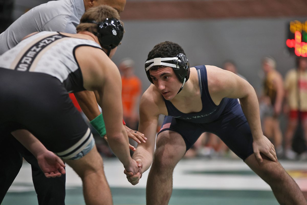 Shaking hands, sophomore Ryder Farley squares off against his opponent.
